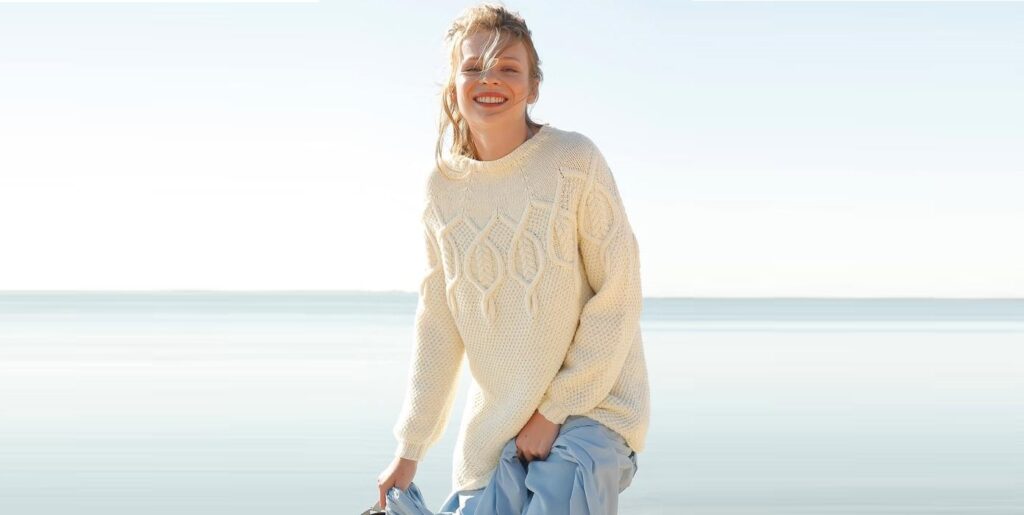 Snow-white sweater with braids on a round yoke