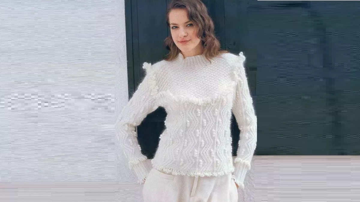 Snow-white jumper with a figured yoke and ruffles