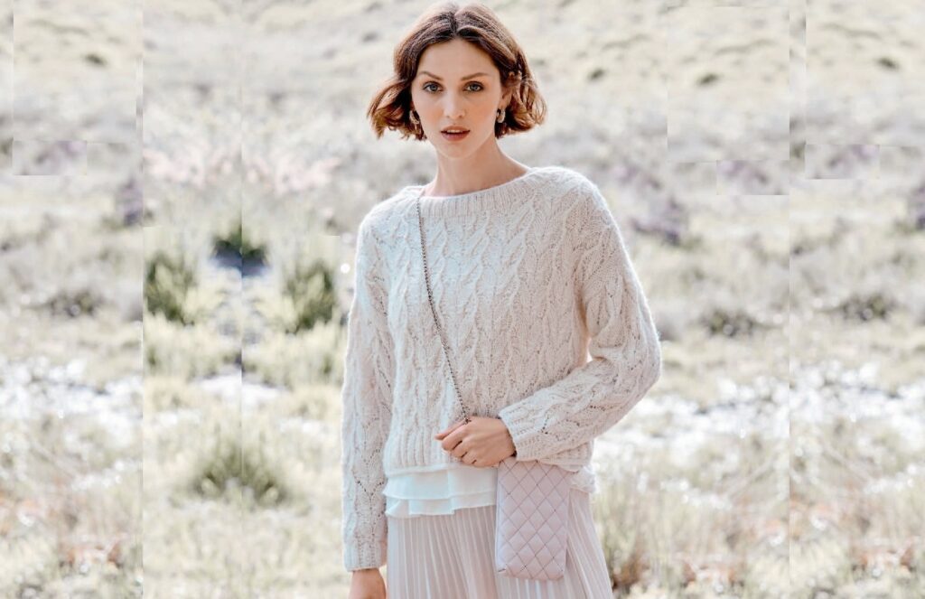 Pullover with long back and openwork pattern